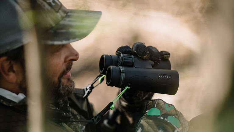 Hunter with Bushnell Engage DX Binoculars in hand