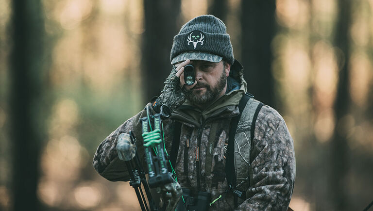 Hunter looking through the BoneCollector 850 Laser Rangefinder